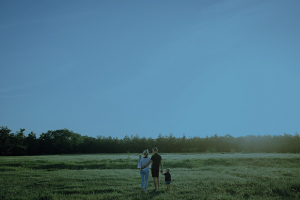 Family walking across a meadow.