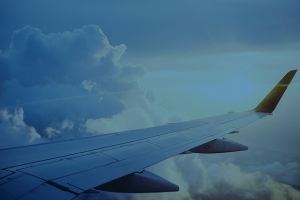 Airplane wing over the clouds.
