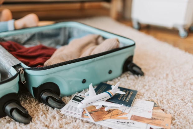 Suitcase on floor with travel documents prepare for sabbatical