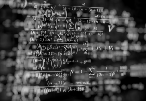mathematical formulas on a black background; photo credit: elchinator