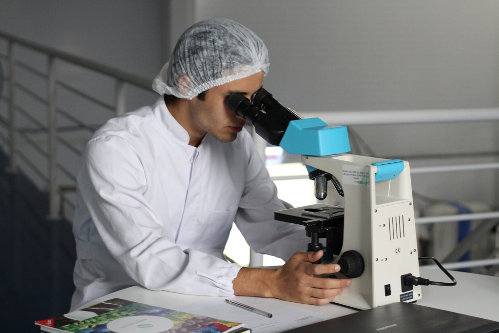 Environmental and STEM Opportunities for Teacher Travel Grants image: man looking through a microscope
