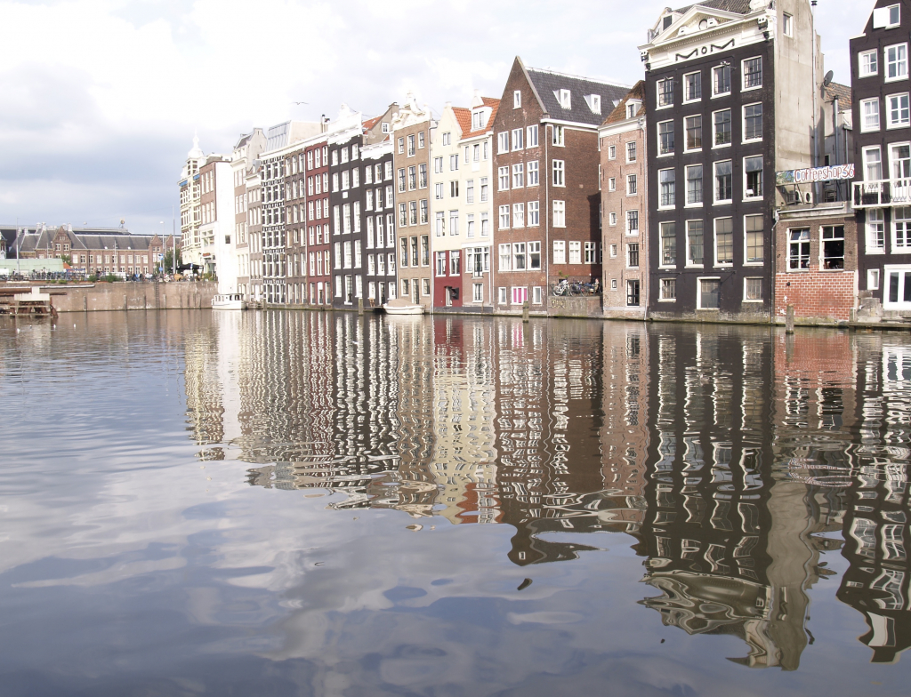 Photo of Damrak, Amsterdam: this stretch (rak) of water was once a part of the Amstel River in central Amsterdam; it was dammed and the water plus the adjacent street are called Damrak. 