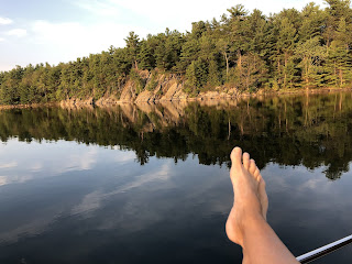 Picture of a person's foot as they are relaxing on a boat.