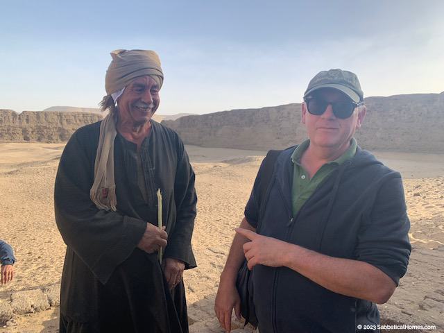Dr. Stephen Harvey at Abydos where an Egyptian aid, Abu Ibrahim, came to say hello during an AIA Tour.