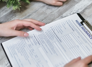 Home insurance paperwork on a clipboard.