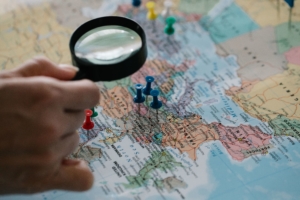 Magnifying glass examining a map.