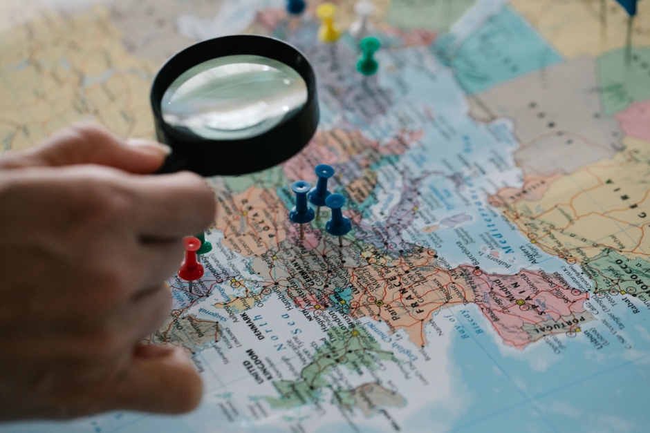 Magnifying glass examining a map.