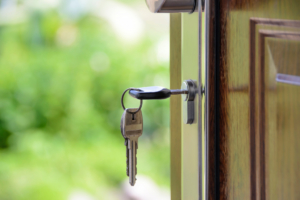 Image of a key in a front door.