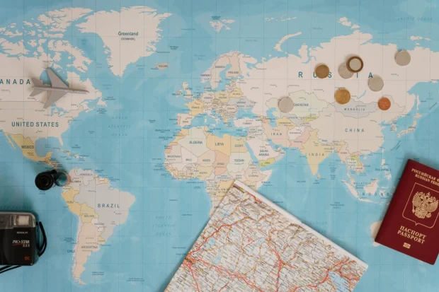 PhD student home exchange; global map, camera, passport, currency; Photo by Tima Miroshnichenko